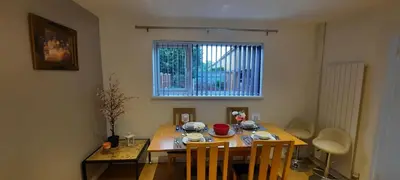 a dining room table and chairs in a room at Stevenage Contractors x8 New 3 bedroom House Free Wifi, Parking, Towels all inclusive & Large Garden in Stevenage
