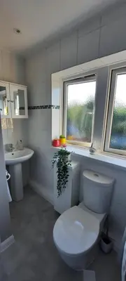 a white bathroom with a toilet and a sink at Stevenage Contractors x8 New 3 bedroom House Free Wifi, Parking, Towels all inclusive & Large Garden in Stevenage