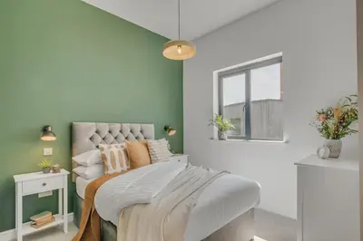 a bedroom with a bed and a window at 4 Bedroom House in Larling, near Thetford in Snetterton