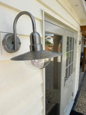 a light hanging on the side of a door at Debussys Guest House in Saffron Walden