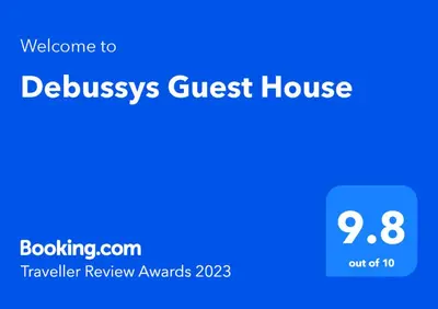 a blue sign with the text welcome to brussels guest house at Debussys Guest House in Saffron Walden