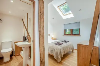a bathroom and a bedroom with a bed and a sink at 3 Bed in Ketteringham oc-1878 in East Carleton