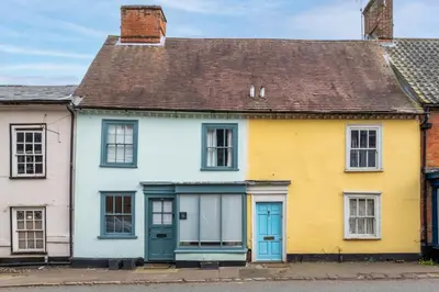 a row of colourful houses on a street at 2 Bed in Halesworth oc-7lr in Halesworth