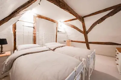 two beds in a attic bedroom with wooden beams at 2 Bed in Halesworth oc-7lr in Halesworth