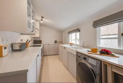 a kitchen with a washing machine in the middle of it at 2 Bed in Halesworth oc-7lr in Halesworth