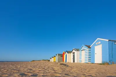 a row of beach houses on a sandy beach at 2 Bed in Halesworth oc-7lr in Halesworth