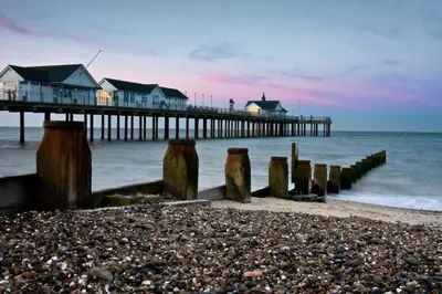 a pier with houses on the beach next to the ocean at 2 Bed in Halesworth oc-7lr in Halesworth