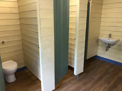 a bathroom with a toilet and a sink at The Tawny Shepherd Hut, Whitehouse Farm in Stowmarket