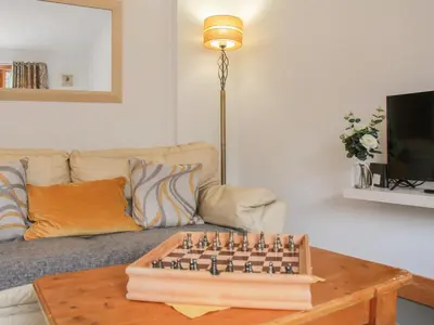 a living room with a chess board on a table at Haycart Barn in Norwich