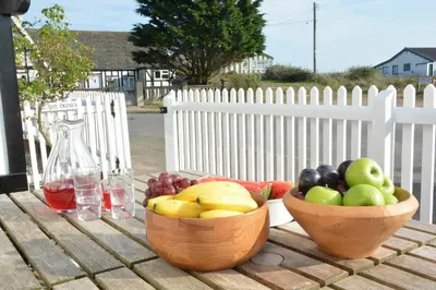 two bowls of fruit sitting on a wooden table at 2 The Dunes, Thorpeness in Thorpeness