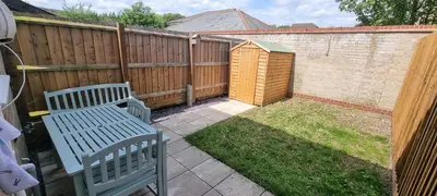 a backyard with two benches and a fence at Shirely S, Milton, Cambridge, 2BR House, Newly Refurbished in Milton