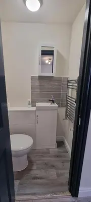 a bathroom with a white toilet and a sink at Shirely S, Milton, Cambridge, 2BR House, Newly Refurbished in Milton