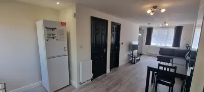 a living room with a black door and a black refrigerator at Shirely S, Milton, Cambridge, 2BR House, Newly Refurbished in Milton