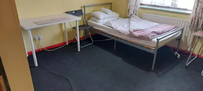 a hospital room with a bed and a desk at Basildon House of Muralist in Basildon