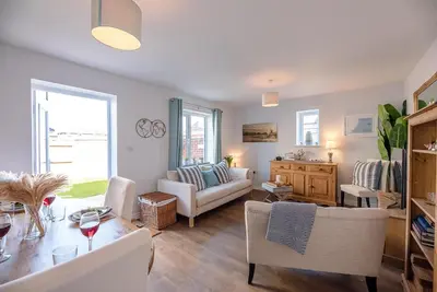 a living room with a couch and a table at Alde Seagull, Aldeburgh in Aldeburgh