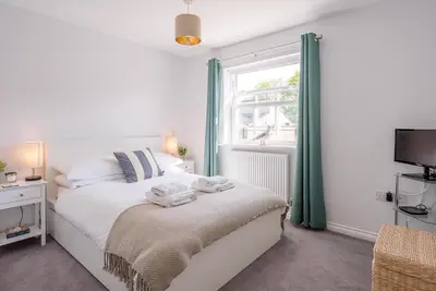 a bedroom with a bed and a window at Alde Seagull, Aldeburgh in Aldeburgh