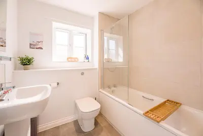 a bathroom with a sink and a toilet and a bath tub at Alde Seagull, Aldeburgh in Aldeburgh