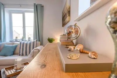 a living room with a table with shells on it at Alde Seagull, Aldeburgh in Aldeburgh
