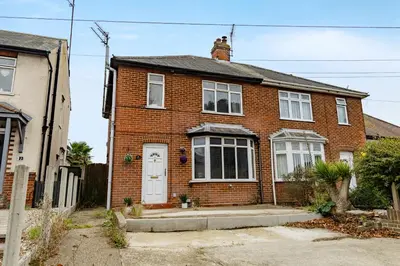 a brick house with a cat on top of it at The Comfy Contractors Resort, Free Private Parking & Wifi, 7 beds in Colchester