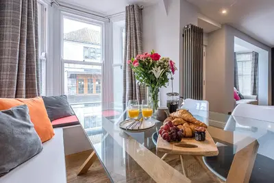 a living room with a glass table with food on it at The Picture House, Aldeburgh in Aldeburgh