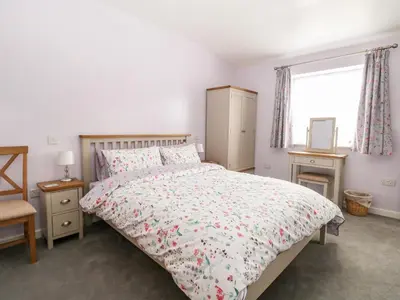 a bedroom with a bed and a window at Jimmys Place in Diss