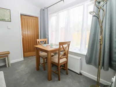 a room with a table and two chairs and a window at Jimmys Place in Diss