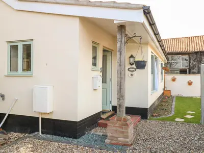 a house with a pillar in front of it at Jimmys Place in Diss