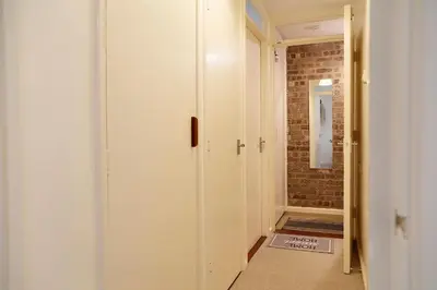 a hallway with a white door and a brick wall at Pass the Keys 1BR Modern Beautiful House Pass the Keys in Cambridge