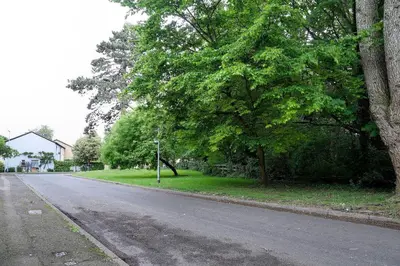 an empty street with trees on the side of the road at Pass the Keys 1BR Modern Beautiful House Pass the Keys in Cambridge