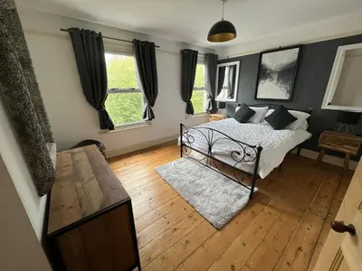 a bedroom with a bed and a wooden floor at Charming 3 bedroom property in Bury St Edmunds in Bury Saint Edmunds