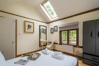 a bedroom with two beds and a skylight at The Cart Lodge - Aldeburgh Coastal Cottages in Wickham Market