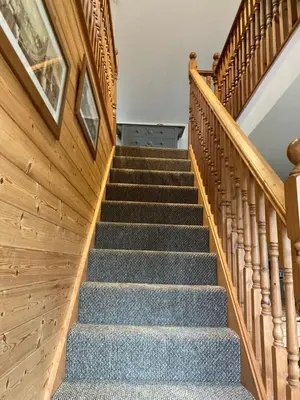 a staircase in a house with wooden walls at The Shed in Long Stratton