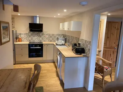 a kitchen with a table and a counter top at The Shed in Long Stratton