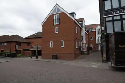 a red brick building on a street with buildings at Toothbrush Apartments - Central Ipswich - Gipping Mews in Ipswich