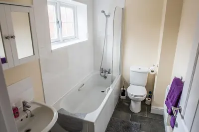 a bathroom with a white tub and a toilet and a sink at Toothbrush Apartments - Central Ipswich - Gipping Mews in Ipswich