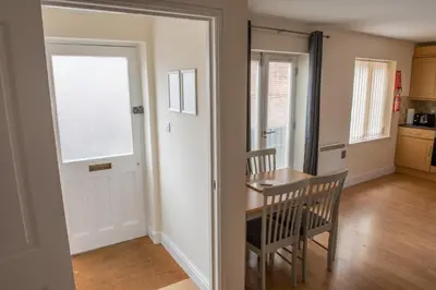 a kitchen with a table and a chair and a window at Toothbrush Apartments - Central Ipswich - Gipping Mews in Ipswich