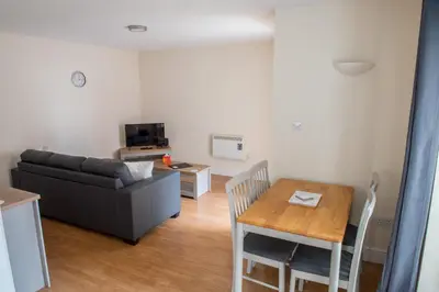 a living room with a couch and a table at Toothbrush Apartments - Central Ipswich - Gipping Mews in Ipswich