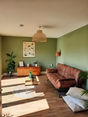 a living room with a brown leather couch at Cranfield Retreat & Glamping in Long Melford