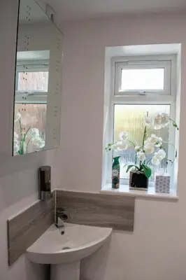 a bathroom with a sink and a window at 121 Studio - Apartment with Kitchen, Terrace, Stansted Airport Shuttle in Bishops Stortford