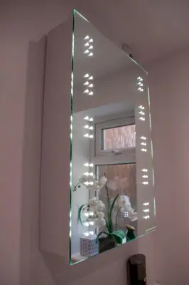 a mirror on a wall with lights on it at 121 Studio - Apartment with Kitchen, Terrace, Stansted Airport Shuttle in Bishops Stortford