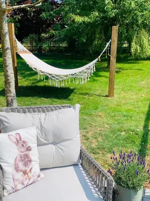 a pillow with a bunny on it sitting on a couch at The Dragonfly Shepherds Hut in Colchester