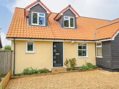 a yellow house with an orange roof at Walnut Shade in Attleborough