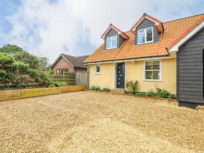 a detached house with a gravel driveway at Walnut Shade in Attleborough