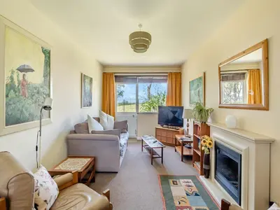 a living room with a couch and a tv at Beach View Cottage in Felixstowe