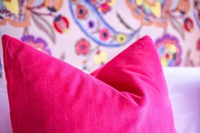 a pink blanket sitting on top of a bed at The Carpenters Arms in Great Wilbraham