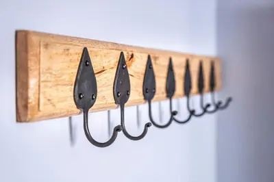 a row of knives hanging on a wooden holder at The Carpenters Arms in Great Wilbraham