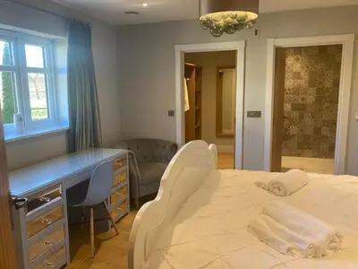 a bedroom with a bed and a desk and a chair at The Oaks Stable cottage in Haughley