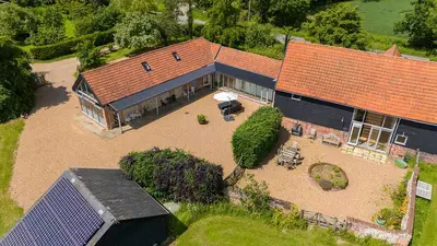 an aerial view of a house with a large yard at The Suites at Pannells Ash in Castle Hedingham