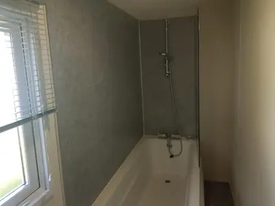 a bathroom with a shower and a bath tub at Lodge Sleeps 8- Parking Wifi Campsite Amenities in Jaywick Sands