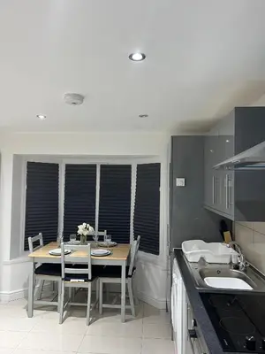 a kitchen with a table with chairs and a sink at Lovely holiday home in Southminster in Southminster